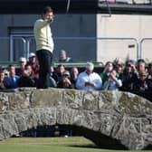 Sir Nick Faldo of England waves to the crowd as he stands on Swilcan Bridge during the second round of the 144th Open Championship at The Old Course on July 17, 2015 in St Andrews, Scotland