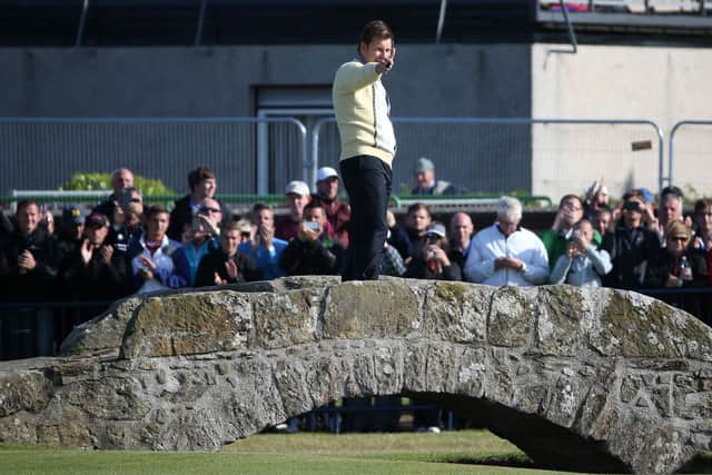 Sir Nick Faldo of England waves to the crowd as he stands on Swilcan Bridge during the second round of the 144th Open Championship at The Old Course on July 17, 2015 in St Andrews, Scotland
