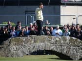 Sir Nick Faldo of England waves to the crowd as he stands on Swilcan Bridge during the second round of the 144th Open Championship at The Old Course on July 17, 2015 in St Andrews, Scotland
