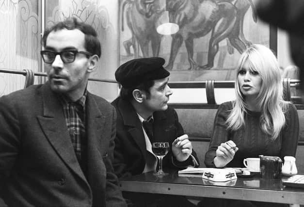 French actress Brigitte Bardot chats with actor Antoine Bourseiller during filming of Masculin-Feminin, directed by Jean-Luc Godard, left, in Paris in 1965 (Picture: AFP via Getty Images)