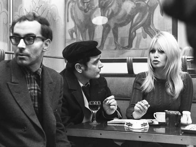 French actress Brigitte Bardot chats with actor Antoine Bourseiller during filming of Masculin-Feminin, directed by Jean-Luc Godard, left, in Paris in 1965 (Picture: AFP via Getty Images)