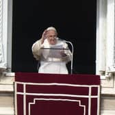 Pope Francis delivers his blessing as he recites the Angelus noon prayer from the window of his studio overlooking St. Peter's Square, at the Vatican, Sunday, Jan. 1