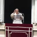 Pope Francis delivers his blessing as he recites the Angelus noon prayer from the window of his studio overlooking St. Peter's Square, at the Vatican, Sunday, Jan. 1