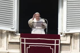 Pope Francis delivers his blessing as he recites the Angelus noon prayer from the window of his studio overlooking St. Peter's Square, at the Vatican, Sunday, Jan. 1