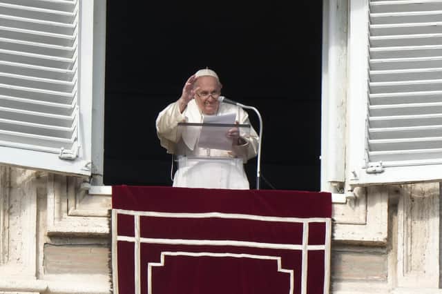 Pope Francis delivers his blessing as he recites the Angelus noon prayer from the window of his studio overlooking St. Peter's Square, at the Vatican, Sunday, Jan. 1