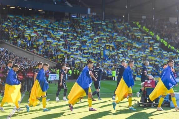The teams enter the field during a FIFA World Cup Play-Off Semi Final between Scotland and Ukraine at Hampden Park