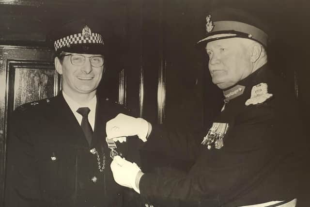 Sandy Marr being presented with the British Empire Medal by Lord Kilmany on April 7, 1977.