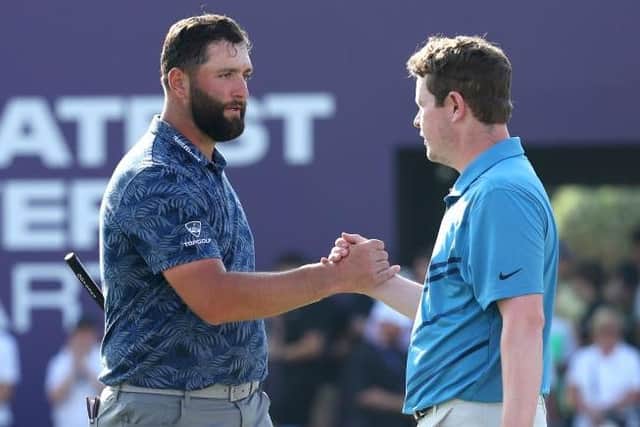 Jon Rahm and Bob MacIntyre shake hands after playing together in the DP World Tour Championship in Dubai in November. Picture: Andrew Redington/Getty Images.