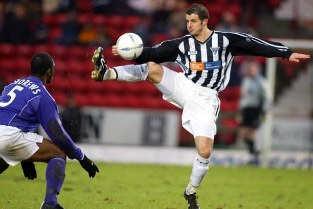 Crawford in action for Dunfermline against Livingston defender Marvin Andrews.