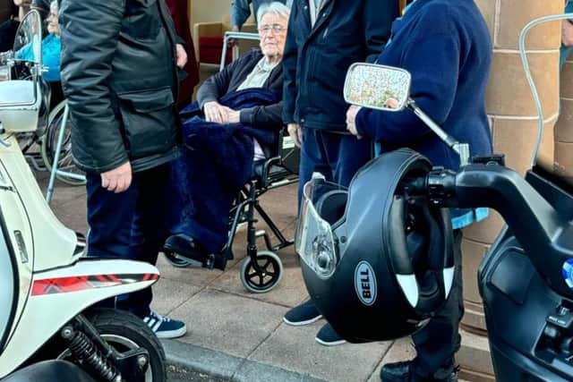 Tommy speaking with a member of the motorcycle group