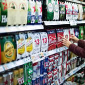 How much longer will alcoholic drinks be allowed to remain on display in shops if a ban on advertising is in place?