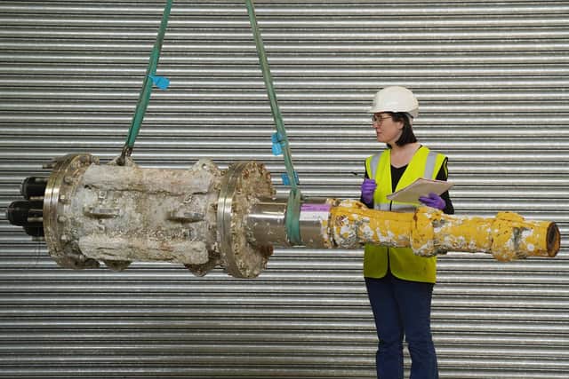 Dr Ellie Swinbank with part of the MeyGen tidal turbine, acquired by NMS. PIC: Stewart Attwood