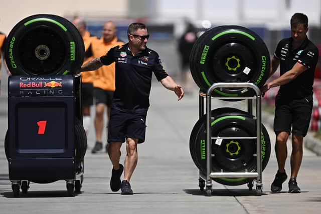 The Red Bull Racing team and Mercedes team transport wheels through the paddock during previews ahead of the F1 Grand Prix of Bahrain at Bahrain International Circuit. Photo: Clive Mason/Getty Images.