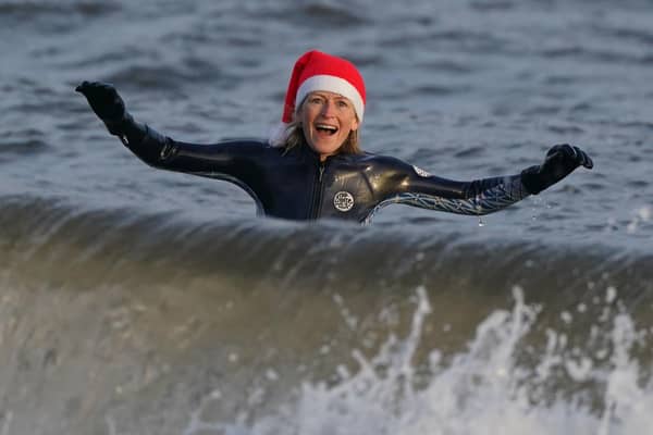 A wild swimmer takes a Christmas Day dip at Portobello Beach in Edinburgh.  Andrew Milligan/PA Wire