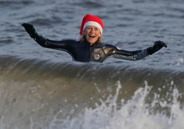 A wild swimmer takes a Christmas Day dip at Portobello Beach in Edinburgh. Andrew Milligan/PA Wire