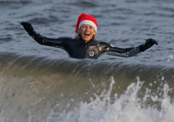 A wild swimmer takes a Christmas Day dip at Portobello Beach in Edinburgh.  Andrew Milligan/PA Wire