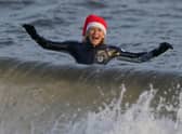A wild swimmer takes a Christmas Day dip at Portobello Beach in Edinburgh.  Andrew Milligan/PA Wire