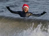 A wild swimmer takes a Christmas Day dip at Portobello Beach in Edinburgh.  Andrew Milligan/PA Wire