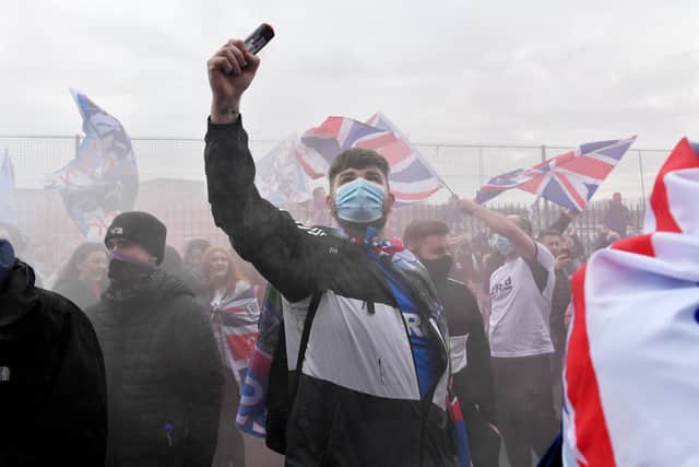 Rangers fans set off smoke bombs as they gather outside the Ibrox Stadium, to celebrate their team winning the Scottish Premiership title on March 07, 2021 in Glasgow, Scotland. (Photo by Mark Runnacles/Getty Images)