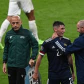 Scotland's midfielder Billy Gilmour (C) and Scotland's coach Steve Clarke (R) react after the UEFA EURO 2020 Group D  match between England and Scotland at Wembley. (Photo by FACUNDO ARRIZABALAGA/POOL/AFP via Getty Images)