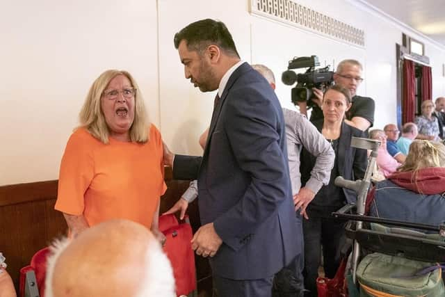 First Minister Humza Yousaf with protester Theresa Mallett, 61, who interrupted his speech at the SNP independence convention at Caird Hall in Dundee. Party members will discuss how Scotland can hold a legally binding referendum for independence.