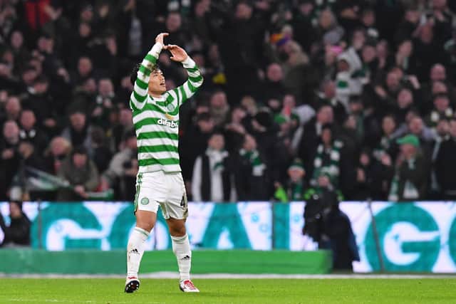 Reo Hatate takes the acclaim of the Celtic fans after scoring his second goal in the 3-0 win over Rangers. (Photo by Mark Runnacles/Getty Images)
