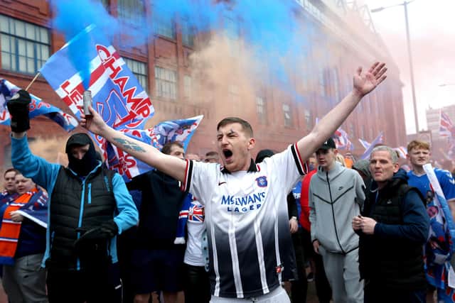 Rangers fans celebrate outside of the Ibrox Stadium after Rangers win the Scottish Premiership title. Picture date: Sunday March 7, 2021.