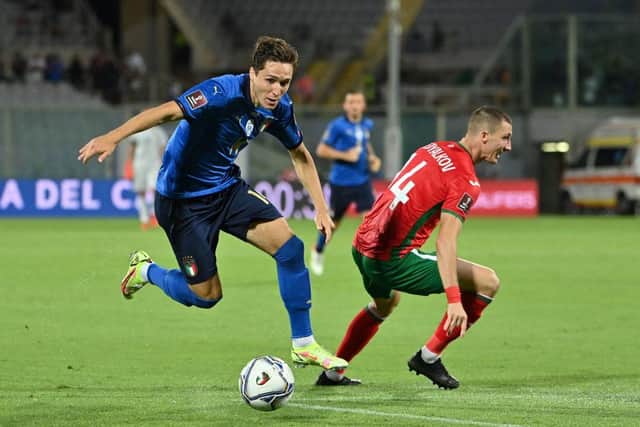 Italy's forward Federico Chiesa (L) and Bulgaria's defender Anton Nedyalkov (R) fight for the ball during the FIFA World Cup Qatar 2022 qualifying round Group C match in Florence. (Photo by ALBERTO PIZZOLI/AFP via Getty Images)