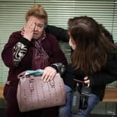 A Ukrainian refugee is comforted by a journalist at Zahony train station in Hungary (Picture: Christopher Furlong/Getty Images)