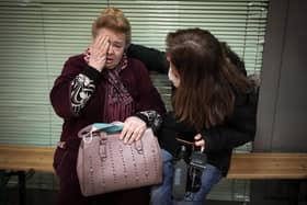 A Ukrainian refugee is comforted by a journalist at Zahony train station in Hungary (Picture: Christopher Furlong/Getty Images)