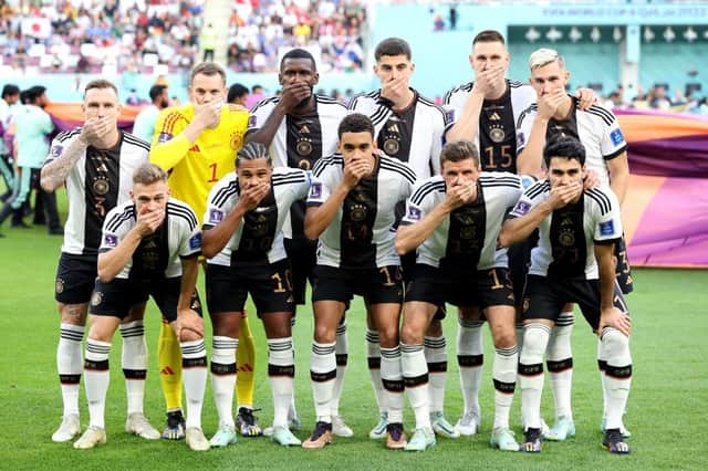 Germany players pose with their hands covering their mouths as they line up for the team photos prior to the FIFA World Cup Qatar 2022 Group E match between Germany and Japan at Khalifa International Stadium on November 23, 2022 in Doha, Qatar. (Photo by Alexander Hassenstein/Getty Images)