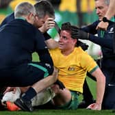 Hearts midfielder Cameron Devlin receives treatment for a blow to the head during Australia's defeat by Ecuador.