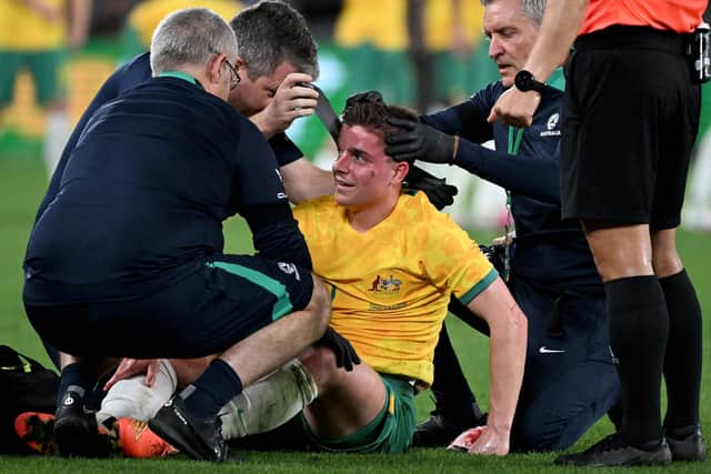 Hearts midfielder Cameron Devlin receives treatment for a blow to the head during Australia's defeat by Ecuador.