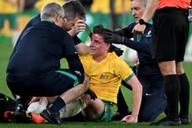 Hearts midfielder Cameron Devlin receives treatment for a blow to the head during Australia's defeat by Ecuador.