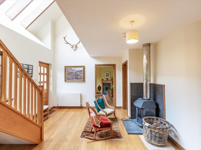 Hallway with wood burning stove and seating area.