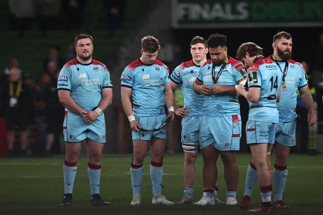 Glasgow Warriors' players look at their medal after their defeat at the end of the European Challenge Cup final against Toulon last summer.