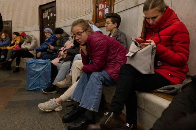 Kyiv residents pass the time in an underground metro station during an air raid alarm. Increased air alarms are becoming more commonplace with the recent drone strikes hitting the capital city.