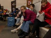 Kyiv residents pass the time in an underground metro station during an air raid alarm. Increased air alarms are becoming more commonplace with the recent drone strikes hitting the capital city.