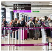 Passengers queue at Edinburgh Airport