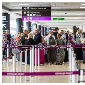 Passengers queue at Edinburgh Airport