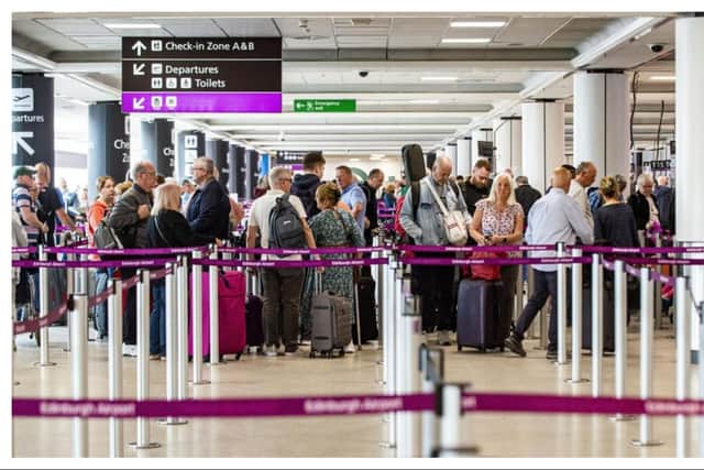 Passengers queue at Edinburgh Airport