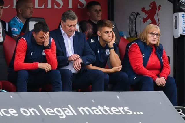 Time is almost up for Dundee in the Premiership as manager Mark McGhee (second left) checks his watch during the 2-0 defeat at St Mirren. (Photo by Ross MacDonald / SNS Group)