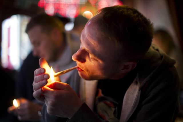A man smokes cannabis in a coffee shop in Amsterdam.