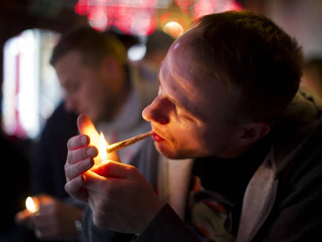 A man smokes cannabis in a coffee shop in Amsterdam.