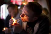A man smokes cannabis in a coffee shop in Amsterdam.