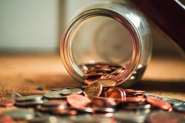 Coins falling out of jar