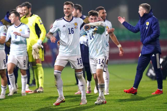Scotland's Liam Cooper (left) and Billy Gilmour celebrate after the 2-0 win over Moldova clinched a World Cup play-off place. (Tim Goode/PA Wire)