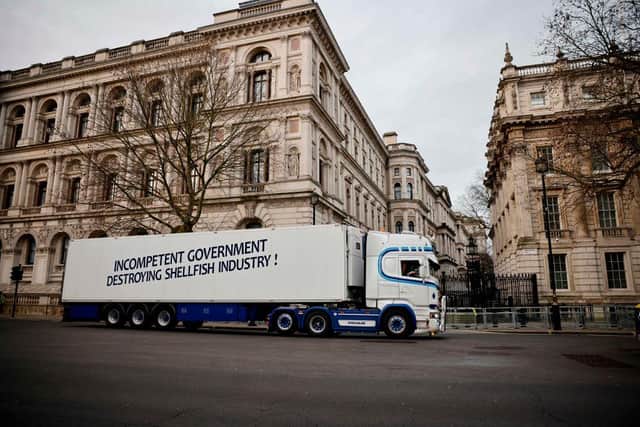 More than 10 of the vehicles have parked up near Downing Street and Westminster to raise awareness of paperwork issues that have left seafood exporters struggling to survive. (Photo by TOLGA AKMEN/AFP via Getty Images)