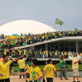 Supporters of Brazilian former President Jair Bolsonaro invade the National Congress in Brasilia on January 8, 2023. - Hundreds of supporters of Brazil's far-right ex-president Jair Bolsonaro broke through police barricades and stormed into Congress, the presidential palace and the Supreme Court Sunday, in a dramatic protest against President Luiz Inacio Lula da Silva's inauguration last week. (Photo by Sergio Lima / AFP) (Photo by SERGIO LIMA/AFP via Getty Images)