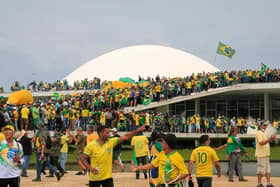 Supporters of Brazilian former President Jair Bolsonaro invade the National Congress in Brasilia on January 8, 2023. - Hundreds of supporters of Brazil's far-right ex-president Jair Bolsonaro broke through police barricades and stormed into Congress, the presidential palace and the Supreme Court Sunday, in a dramatic protest against President Luiz Inacio Lula da Silva's inauguration last week. (Photo by Sergio Lima / AFP) (Photo by SERGIO LIMA/AFP via Getty Images)